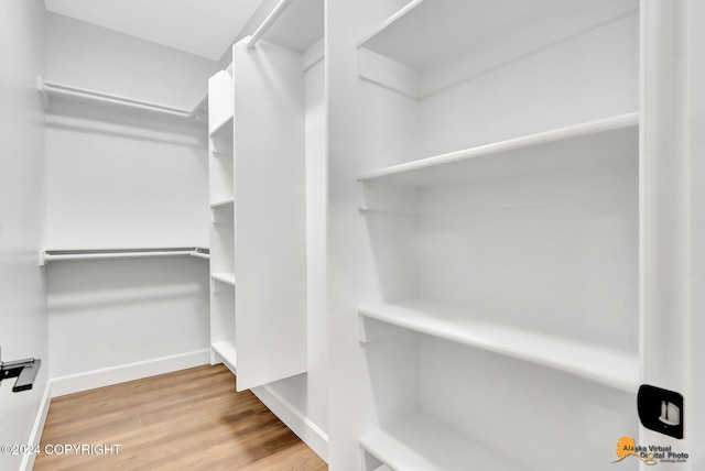 spacious closet featuring hardwood / wood-style floors