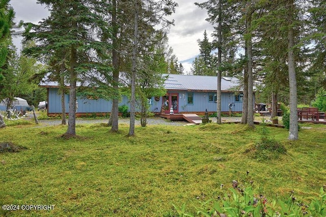 exterior space with a deck and a lawn