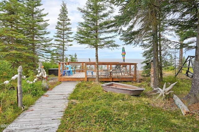 rear view of property featuring a deck with water view