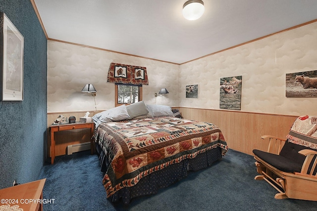 bedroom featuring baseboard heating, ornamental molding, dark colored carpet, and wood walls