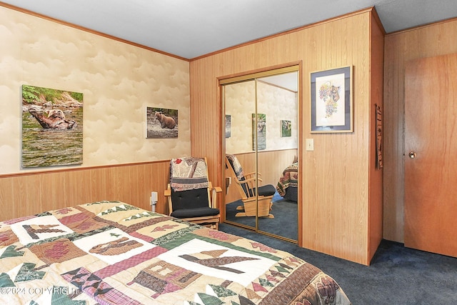 carpeted bedroom with ornamental molding, wooden walls, and a closet