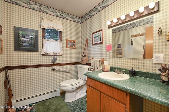 bathroom with baseboard heating, vanity, and toilet