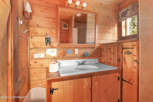 bathroom featuring vanity and wooden walls