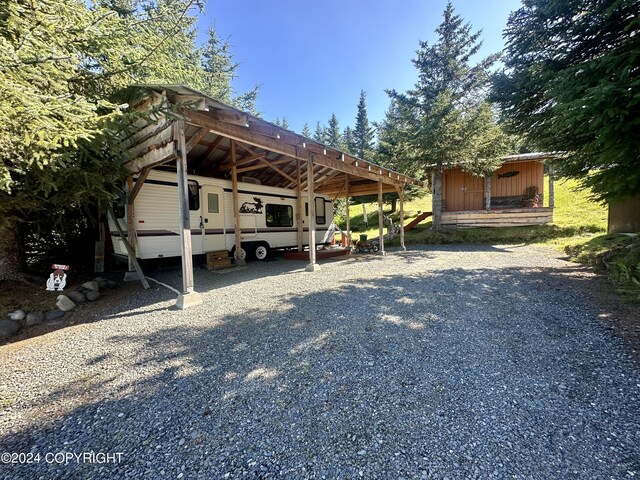 view of vehicle parking featuring a carport