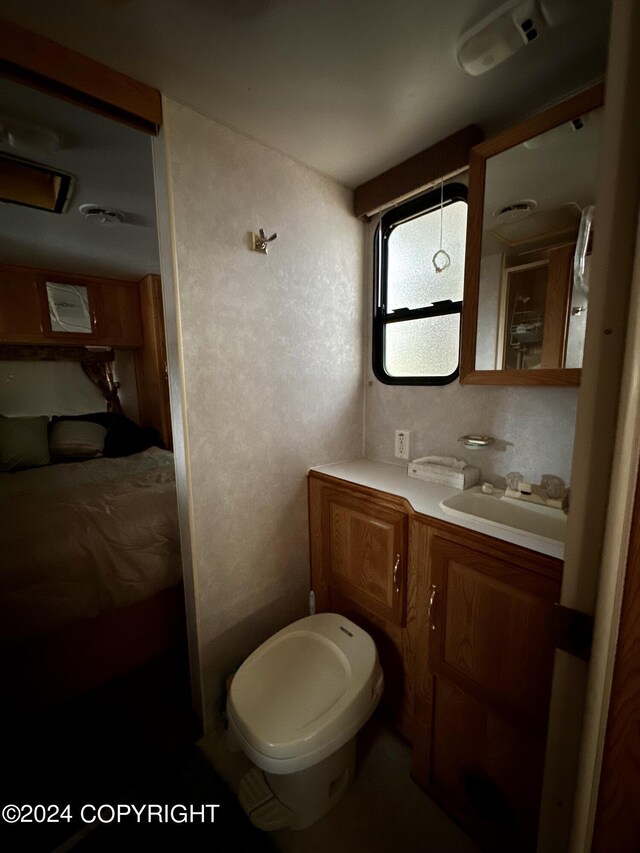 bathroom featuring toilet and vanity