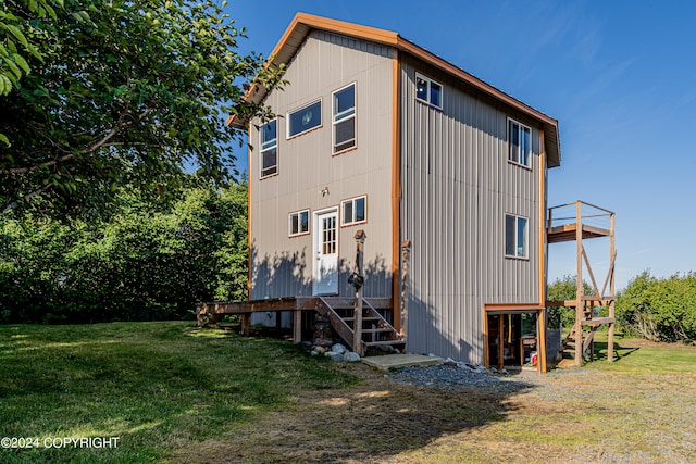 rear view of house featuring a yard