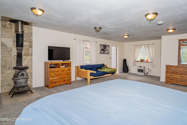 bedroom with light colored carpet and a wood stove