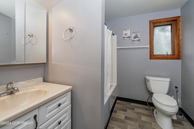 full bathroom featuring vanity, hardwood / wood-style floors, toilet, and shower / bath combo