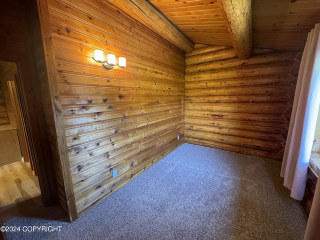 carpeted spare room with beam ceiling, wood ceiling, and rustic walls