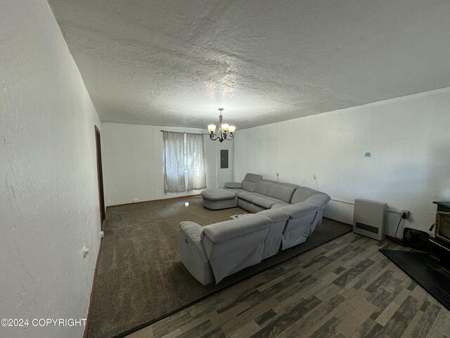 living room featuring hardwood / wood-style flooring, a notable chandelier, and a textured ceiling