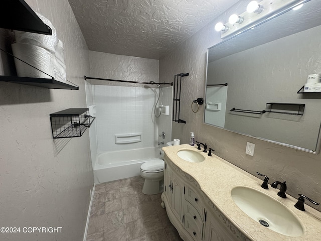 full bathroom featuring toilet, vanity, tile patterned floors, a textured ceiling, and tiled shower / bath