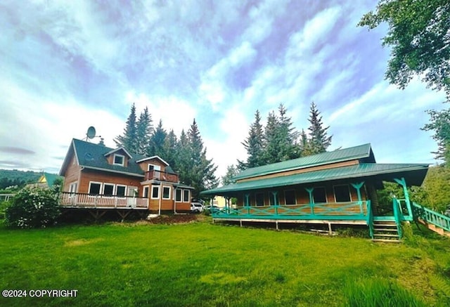 rear view of house featuring a yard