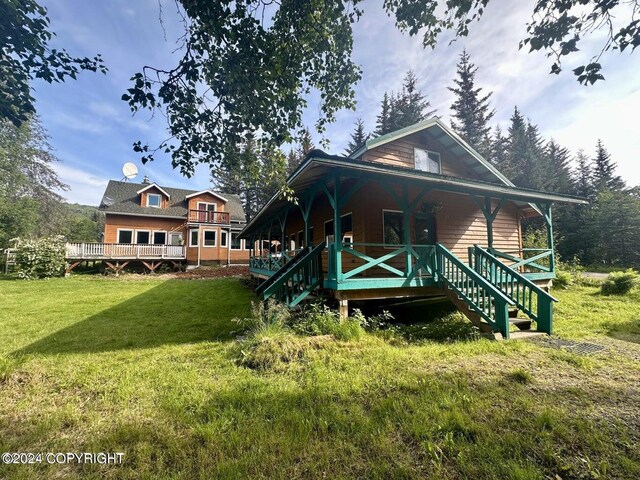 view of front of home with a wooden deck and a front yard