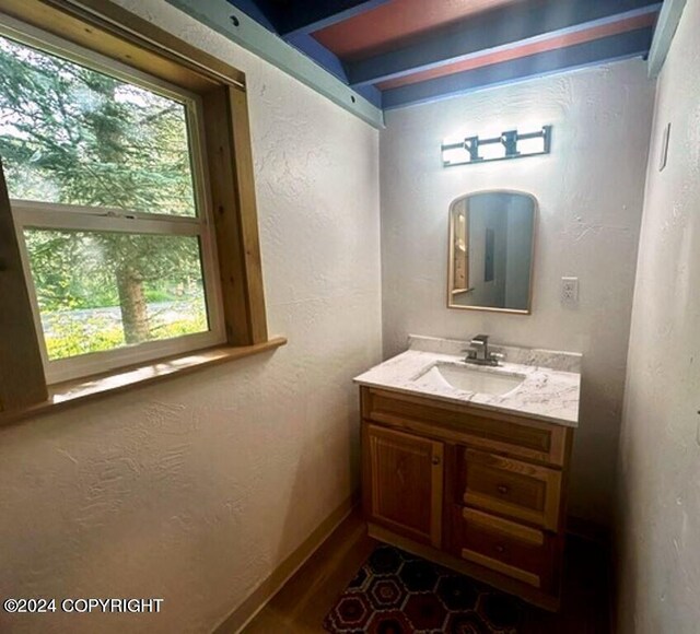 bathroom featuring vanity and beam ceiling