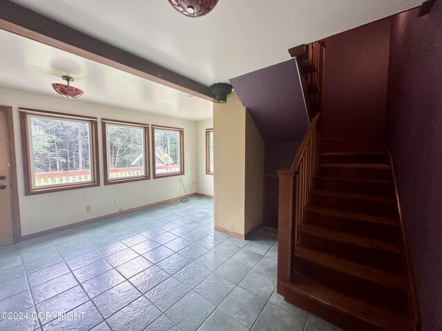 staircase featuring tile patterned floors