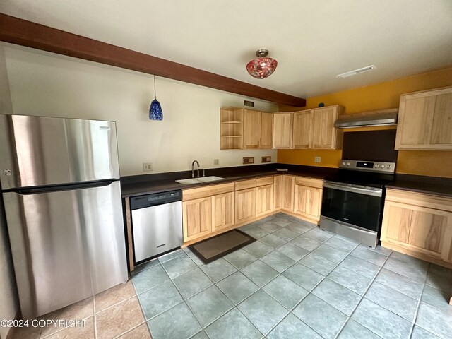 kitchen with appliances with stainless steel finishes, light brown cabinetry, and sink