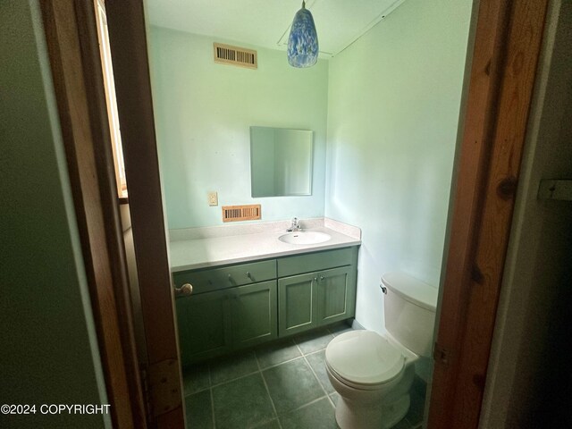 bathroom with tile patterned flooring, toilet, and vanity