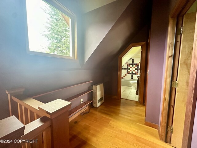 interior space featuring vaulted ceiling and light wood-type flooring