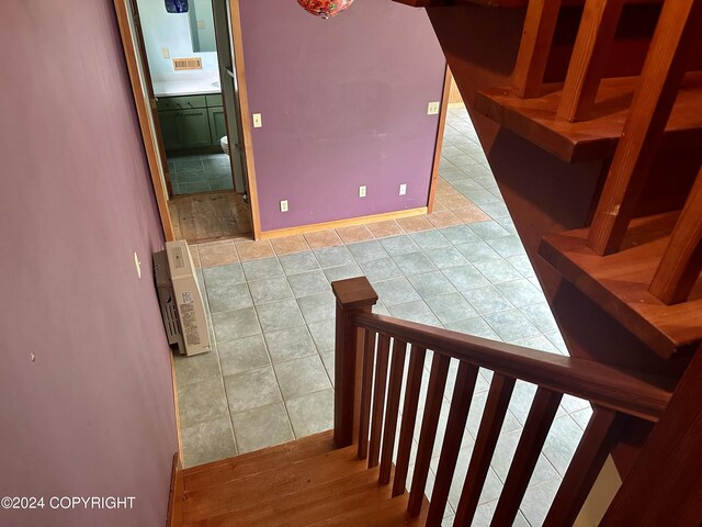 stairway with tile patterned flooring