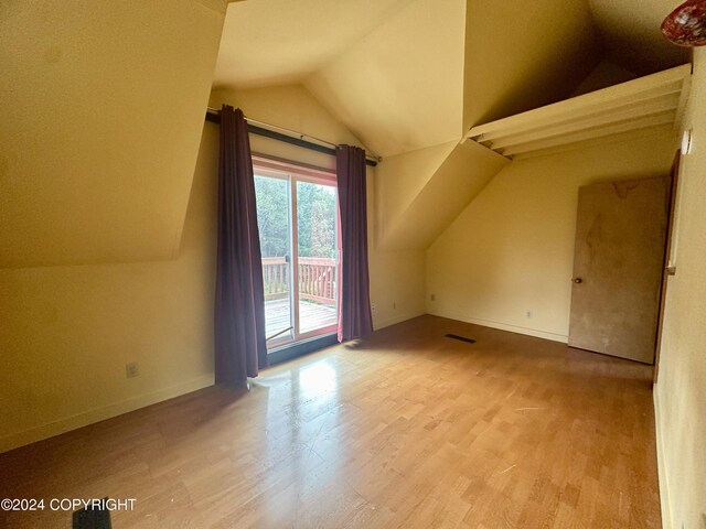 bonus room featuring lofted ceiling and hardwood / wood-style floors