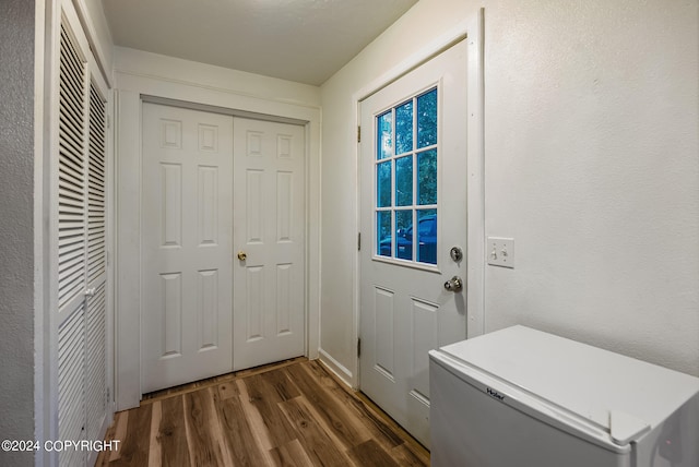 entryway with dark hardwood / wood-style flooring