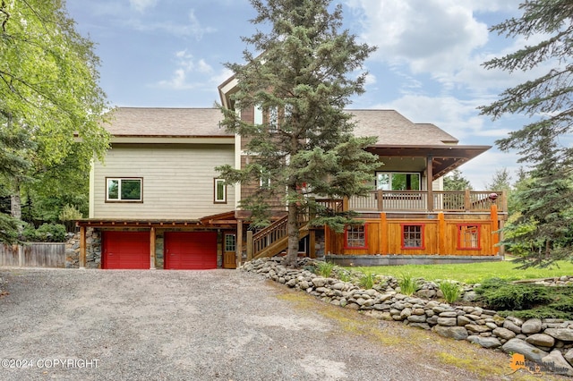 view of front of home with a garage and a deck