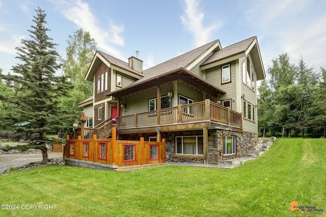 back of property with a wooden deck and a yard