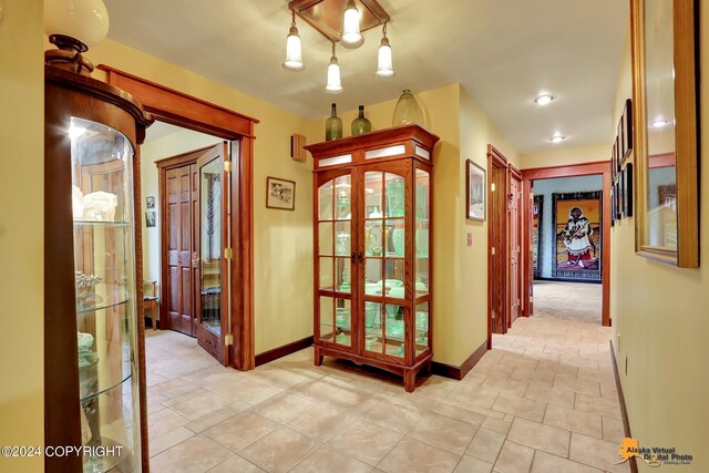 corridor with light tile patterned floors and french doors