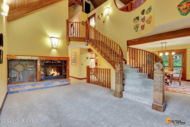 living room with high vaulted ceiling, a fireplace, carpet floors, and beam ceiling