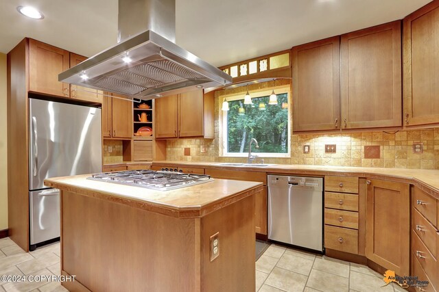 kitchen featuring a center island, island range hood, sink, light tile patterned flooring, and appliances with stainless steel finishes