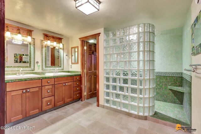 bathroom with tiled shower, tile patterned floors, and vanity