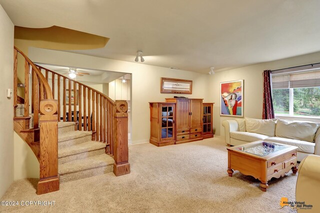 carpeted living room with ceiling fan