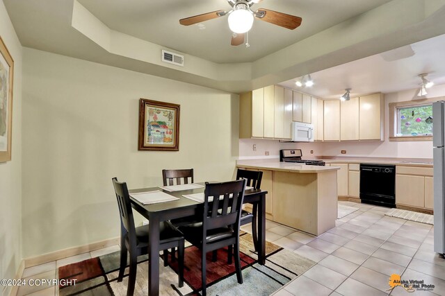 kitchen featuring kitchen peninsula, appliances with stainless steel finishes, ceiling fan, and light tile patterned floors