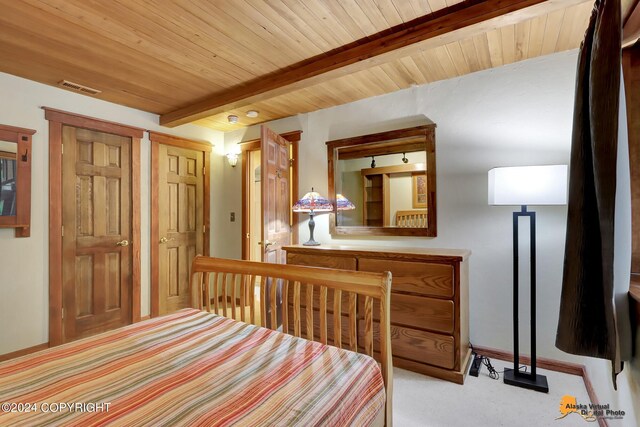 carpeted bedroom featuring wooden ceiling and beamed ceiling