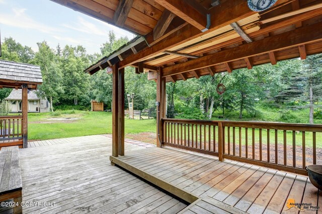 wooden deck with a lawn