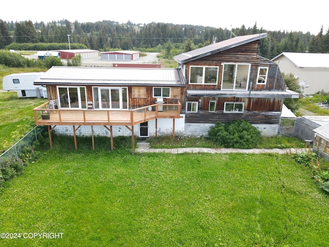 rear view of house featuring a yard and a wooden deck