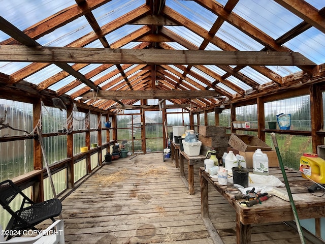 unfurnished sunroom with vaulted ceiling with beams and a healthy amount of sunlight