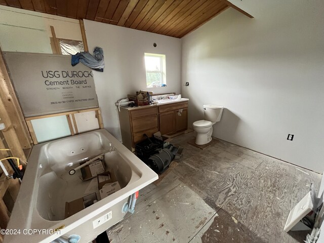 bathroom featuring wood ceiling, toilet, a tub to relax in, and vanity