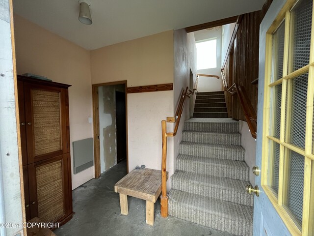 stairs with concrete flooring