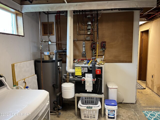 utility room with gas water heater and washer / clothes dryer