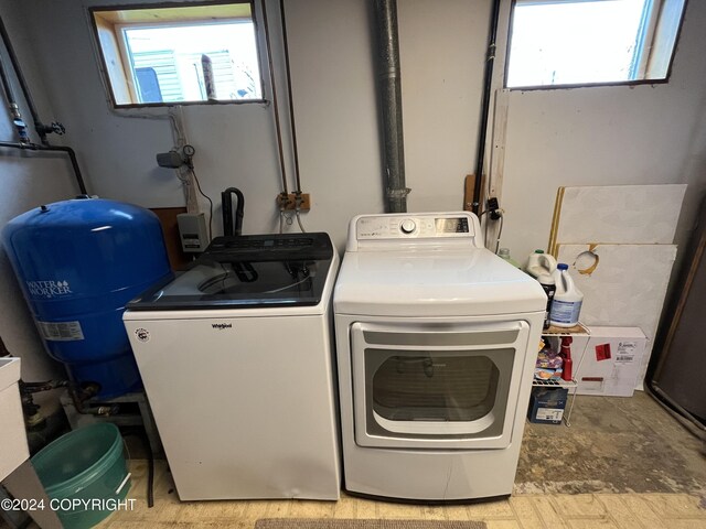 laundry room featuring a healthy amount of sunlight and separate washer and dryer