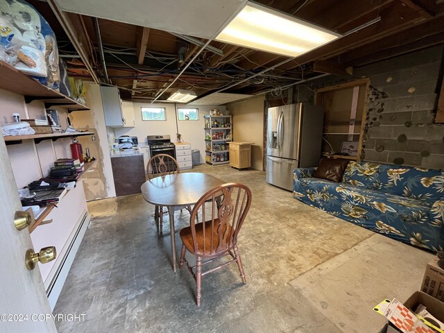 basement with stainless steel fridge and baseboard heating