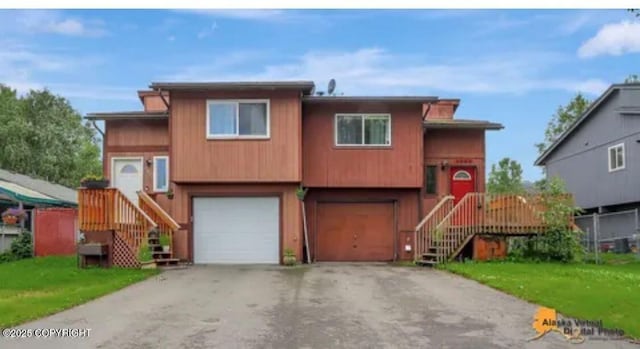 bi-level home featuring a front yard and a garage