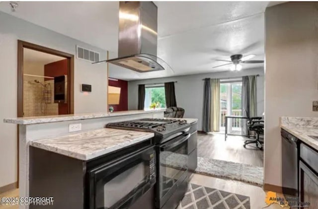 kitchen with range with gas cooktop, island exhaust hood, ceiling fan, light stone countertops, and stainless steel dishwasher