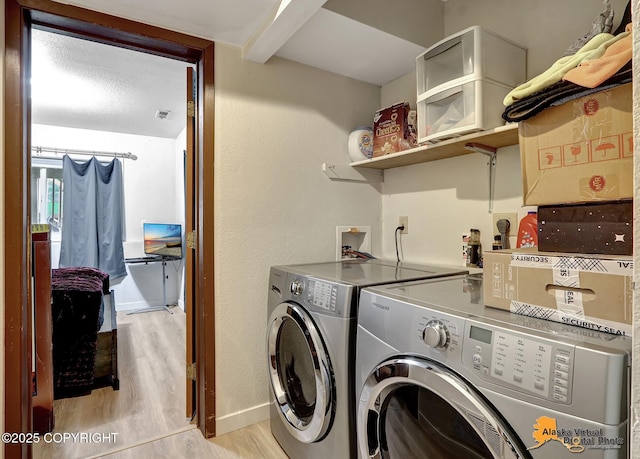 clothes washing area featuring light wood-type flooring and independent washer and dryer