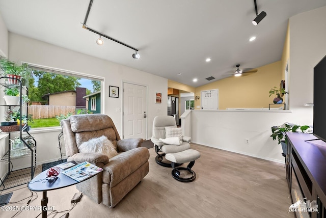 12230 Rainbow Ave, Anchorage, AK 99516 - living area featuring wood finished floors, a ceiling fan, lofted ceiling, recessed lighting, and rail lighting