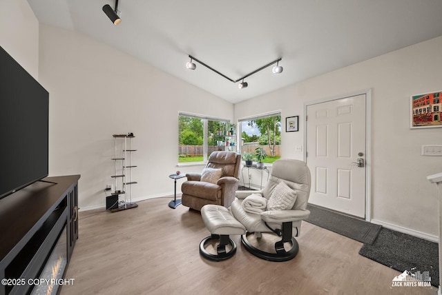 12230 Rainbow Ave, Anchorage, AK 99516 - sitting room with wood finished floors, lofted ceiling, and track lighting