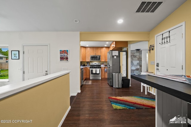 12230 Rainbow Ave, Anchorage, AK 99516 - kitchen with appliances with stainless steel finishes, dark wood-type flooring, brown cabinets, light countertops, and recessed lighting