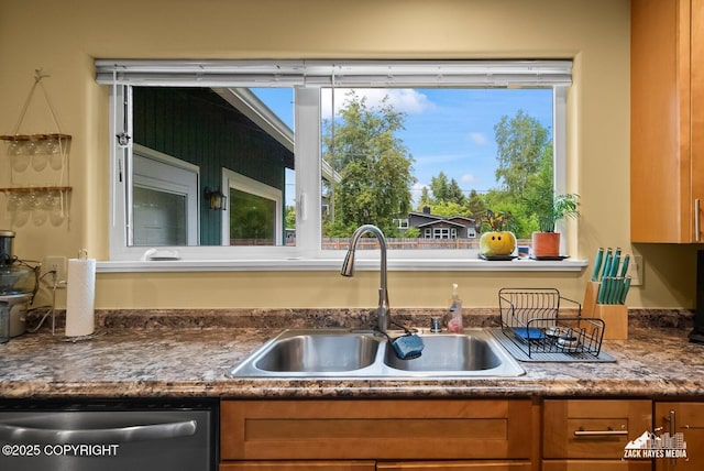 12230 Rainbow Ave, Anchorage, AK 99516 - kitchen featuring dishwasher, brown cabinets, healthy amount of natural light, and dark countertops