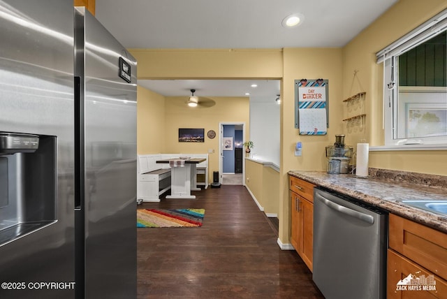 12230 Rainbow Ave, Anchorage, AK 99516 - kitchen with appliances with stainless steel finishes, brown cabinets, dark wood-style flooring, and recessed lighting
